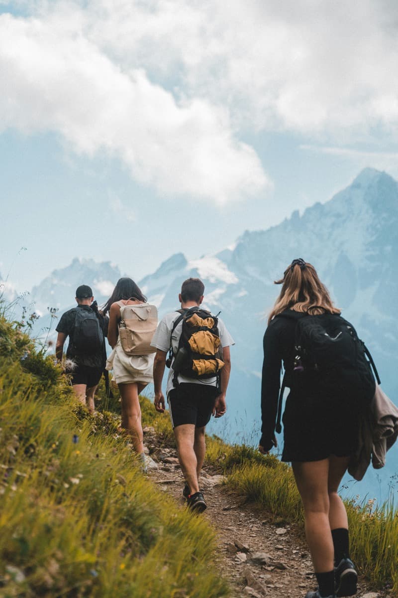 Hikers with backpacks looking out over a mountain trail
